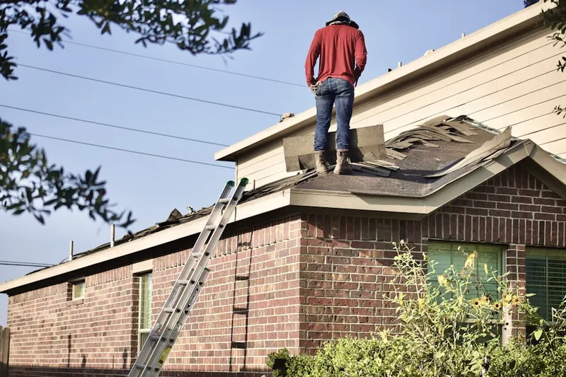 Professional roofer working on a residential roof in Fort Stewart